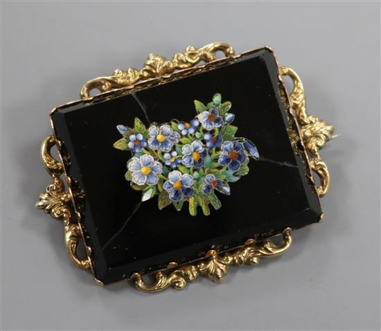A late 19th century yellow metal mounted micro mosaic brooch decorated with flowers (a.f.), 57mm.